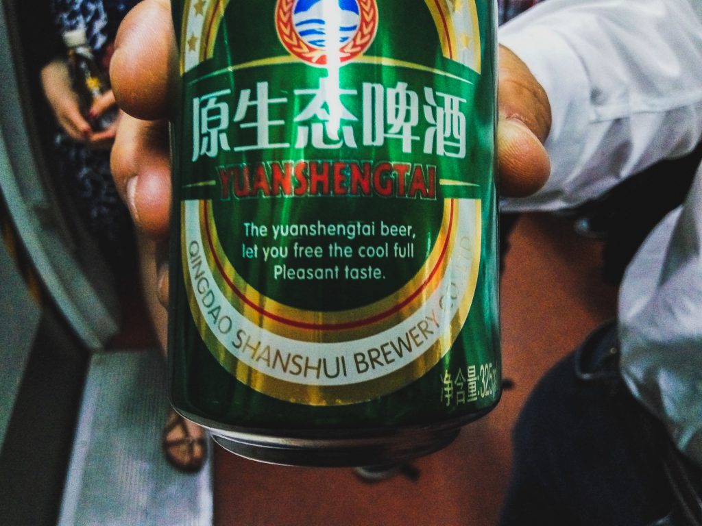 Zblízka fotený nápis na plechovke piva hovoriaci "The yuanshengtai beer, let you free the cool full. Pleasant taste".